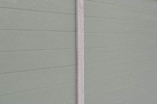 Close-up of a olive grey paneled fence panel in concrete post